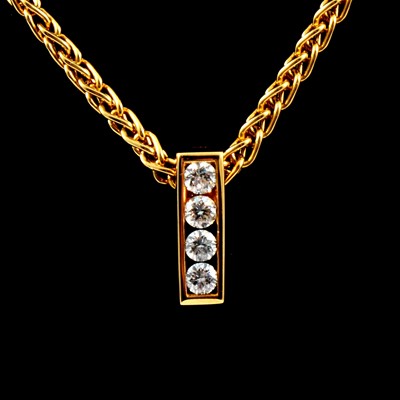 Lot 357 - A diamond four stone pendant and chain.