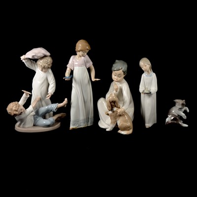 Lot 37 - Four Lladro figurines and five Nao figurines.