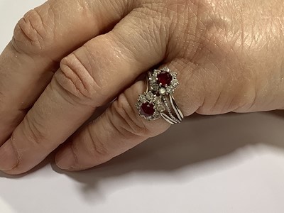 Lot 69 - A ruby and diamond double cluster ring.