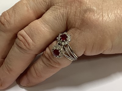 Lot 69 - A ruby and diamond double cluster ring.