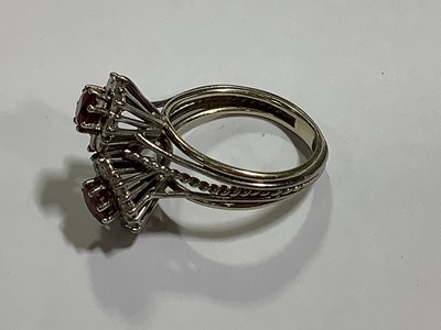 Lot 69 - A ruby and diamond double cluster ring.