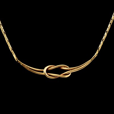 Lot 201 - A 9 carat yellow gold reef gold knot design necklace.