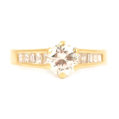 Lot 3 - A diamond solitaire ring with diamond set shoulders.