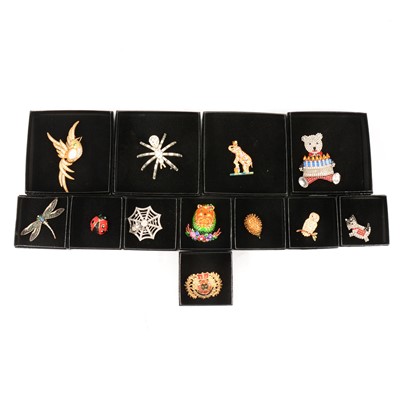 Lot 352 - Butler & Wilson - twelve novelty crystal brooches,  black boxed Circa  1990’s.