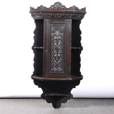 Lot 553 - Carved oak hanging corner cupboard