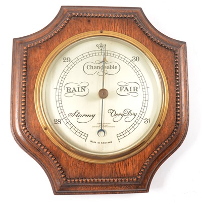 Lot 379 - Oak cased aneroid barometer and an oak framed wall mirror
