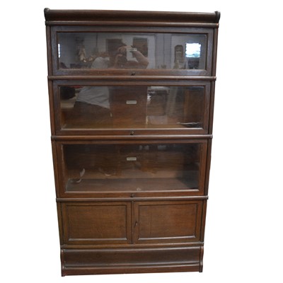 Lot 475 - Oak four-height sectional bookcase, labelled Globe Wernicke