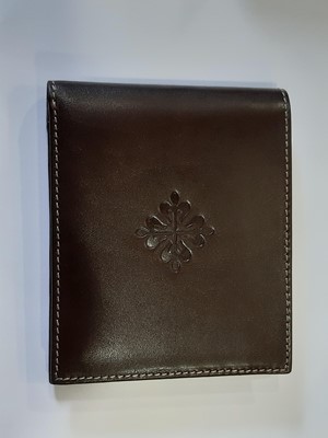 Lot 397 - Patek Philippe Geneve- a brown leather wallet, as new boxed.