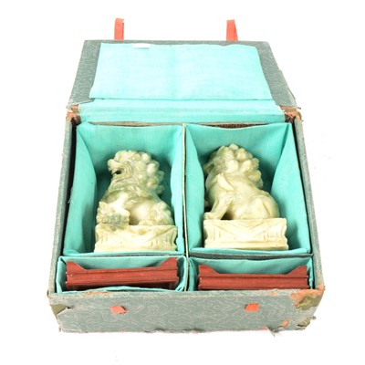 Lot 219 - Pair of carved Jadeite temple lions on stands, boxed