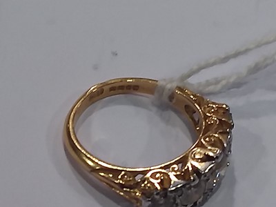 Lot 18 - A diamond five stone reproduction Victorian clarved claw ring.