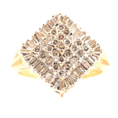 Lot 35 - A diamond cluster ring, brilliant and baguette cut stones.