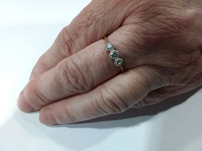 Lot 15 - A diamond three stone ring.
