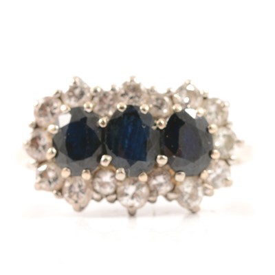 Lot 50 - A sapphire and diamond triple cluster ring.