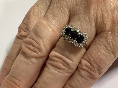 Lot 50 - A sapphire and diamond triple cluster ring.