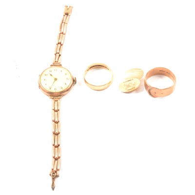 Lot 242 - A lady's vintage gold wristwatch, single cufflink and two rings.