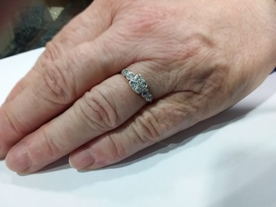 Lot 9 - A diamond solitaire ring and a diamond and white stone ring.