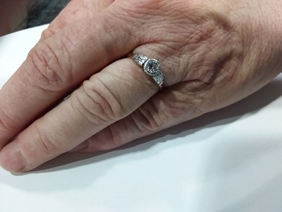 Lot 9 - A diamond solitaire ring and a diamond and white stone ring.