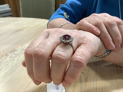 Lot 61 - A garnet and diamond cluster ring.