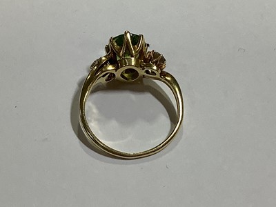 Lot 63 - A peridot and diamond three stone ring.