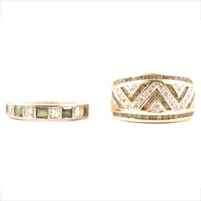 Lot 65 - A diamond and green stone half hoop ring and a diamond and green stone eternity ring.