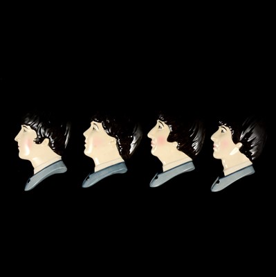 Lot 9 - Set of four Moorland Pottery Beatles face wall plaques.
