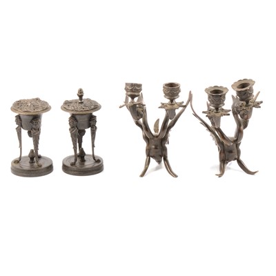 Lot 147 - A pair of bronze two-headed griffin candlesticks; and a pair of lidded bronze incense burners