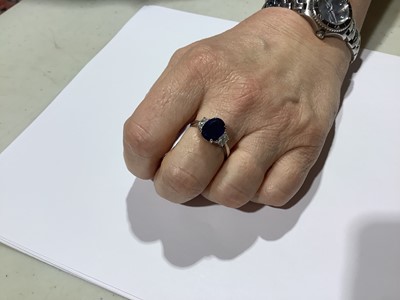 Lot 45 - A sapphire and diamond three stone ring.