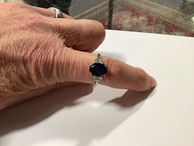 Lot 45 - A sapphire and diamond three stone ring.