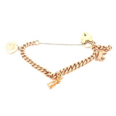 Lot 174 - A 9 carat yellow gold curb link bracelet with padlock fastener and charms.