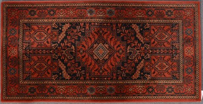 Lot 553 - Modern machine-made rug, red and navy colourway