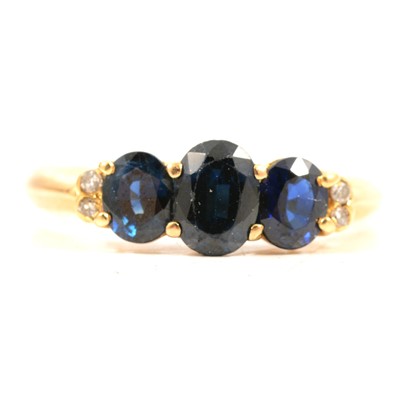 Lot 56 - A sapphire and diamond ring.