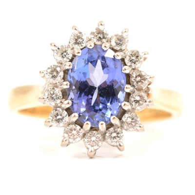 Lot 67 - A tanzanite and diamond cluster ring.