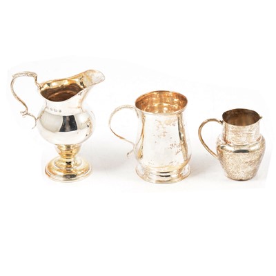 Lot 249 - Small silver cup, maker's mark rubbed, London 1782, and two silver cream jugs.