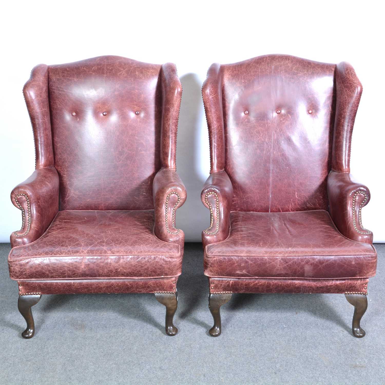 Lot 392 Pair of leather wing back easy chairs,