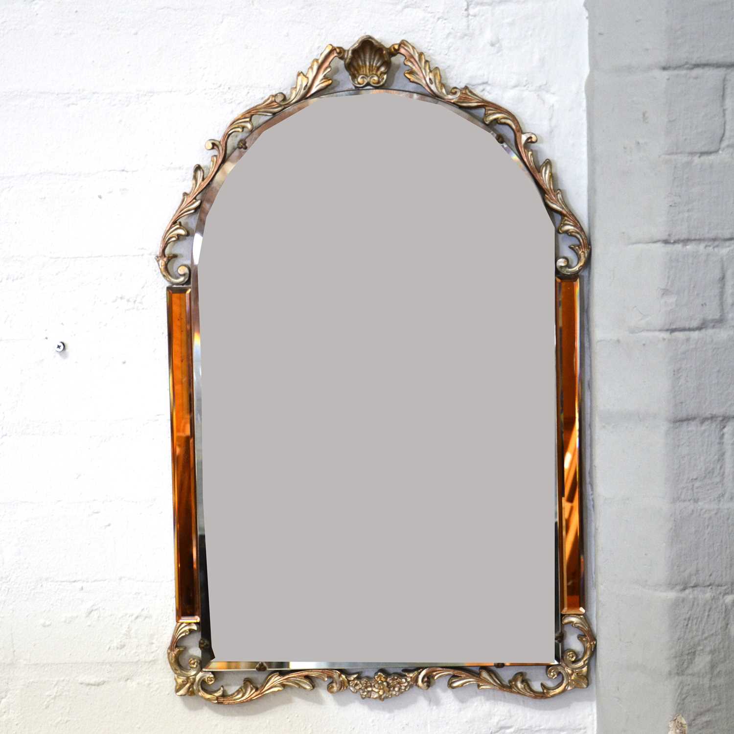 Lot 410 - A decorative wall mirror with peach panels