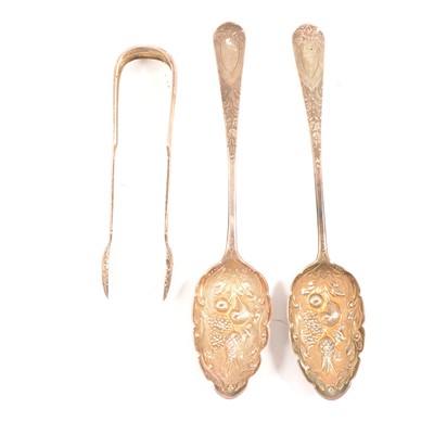 Lot 259 - Two Georgian silver berry spoons, maker's marks rubbed, London 1801 and 1806, and sugar tongs.