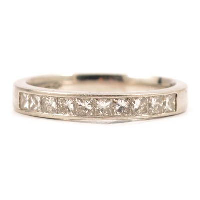 Lot 37 - A diamond half eternity ring set with ten princess cut stones.