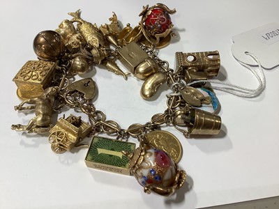 Lot 171 - A 9 carat gold charm bracelet with charms.