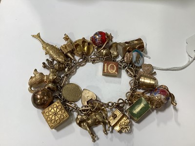 Lot 171 - A 9 carat gold charm bracelet with charms.