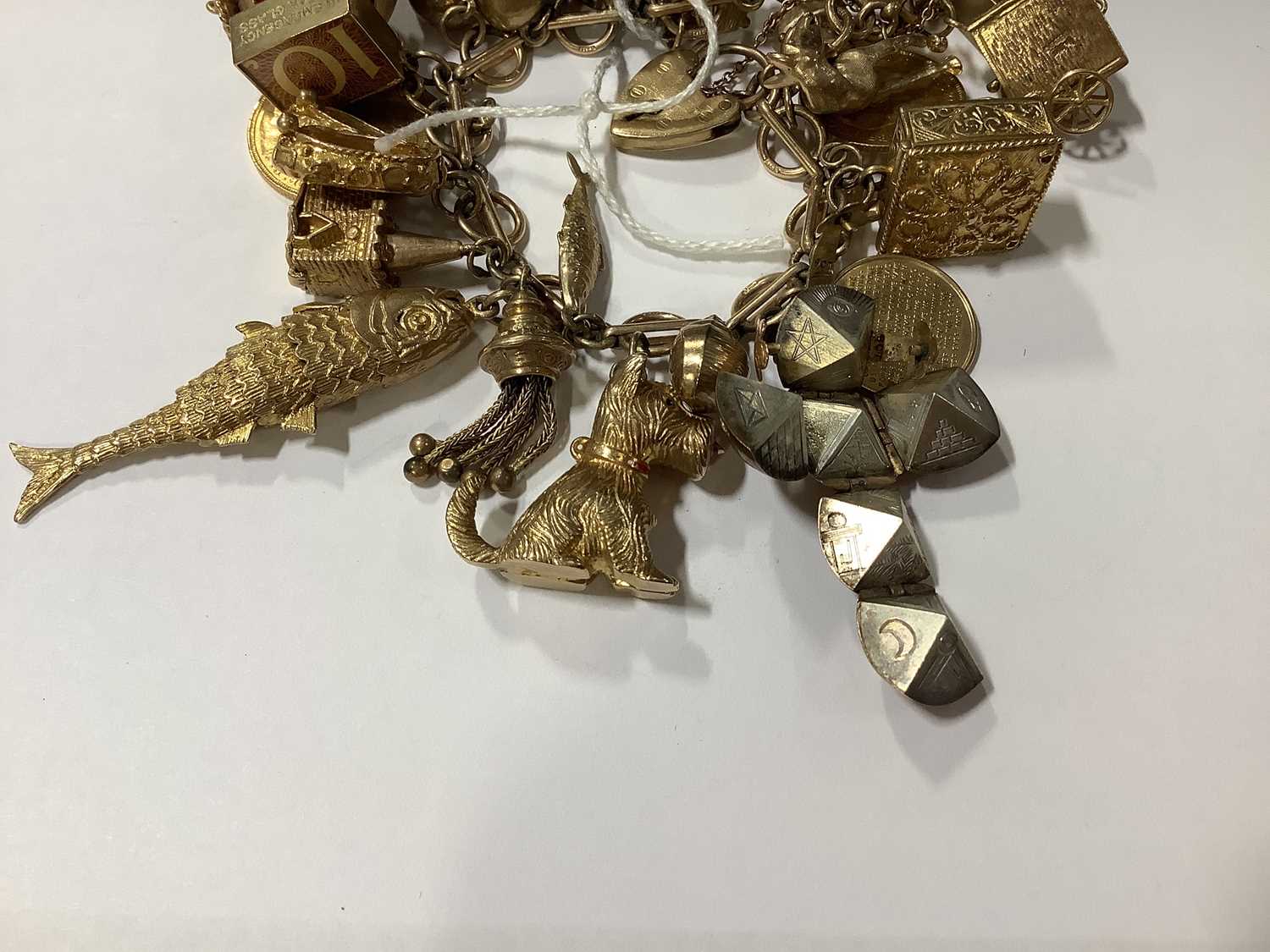 Lot 171 A 9 carat gold charm bracelet with charms.