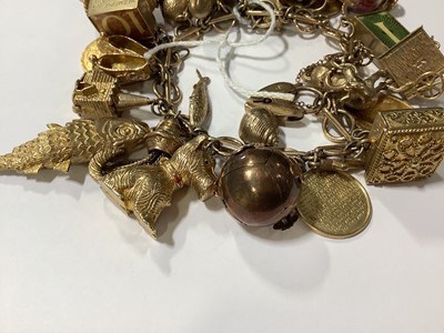 Lot 171 - A 9 carat gold charm bracelet with charms.