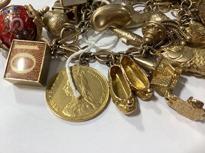 Lot 171 - A 9 carat gold charm bracelet with charms.