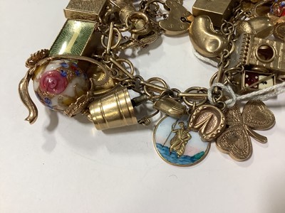 Lot 171 - A 9 carat gold charm bracelet with charms.