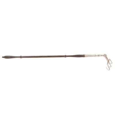 Lot 257 - An antique hinged steel toasting fork with turned wooden handle.