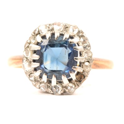 Lot 52 - A sapphire and diamond cluster ring.