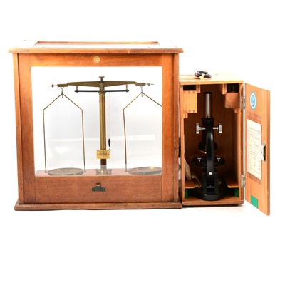 Lot 194 - A student microscope , set of lab balance scales in case with three part sets of weights.