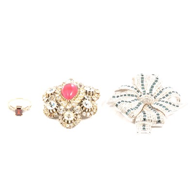 Lot 250 - A Swarovski crystal brooch, vintage brooch and a garnet set 9 carat gold ring.