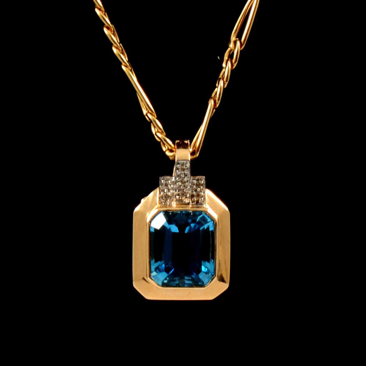 Lot 235 - A heat treated blue topaz pendant and chain.
