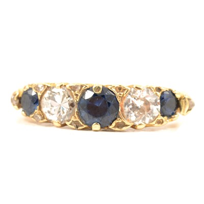 Lot 55 - A sapphire and diamond five stone half hoop ring.