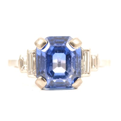 Lot 45 - A sapphire ring with two baguette cut diamonds in each shoulder.